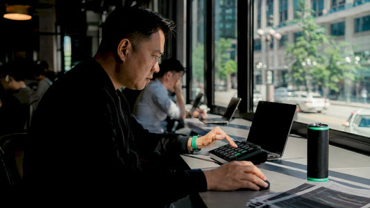 Trader using external trading keypad at desk