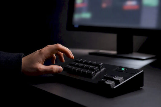 Trader using hardware hotkeys beside trading software