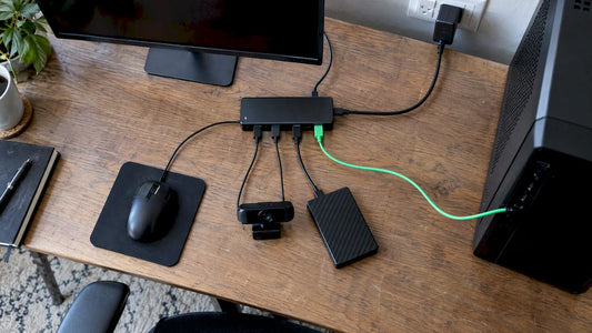 Powered USB hub connected to desk peripherals