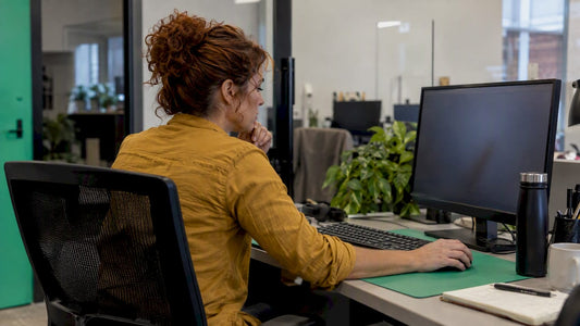 Trader revising a working order at her monitor
